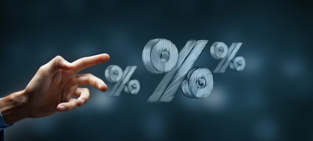 Hand reaching towards floating percentage symbols.